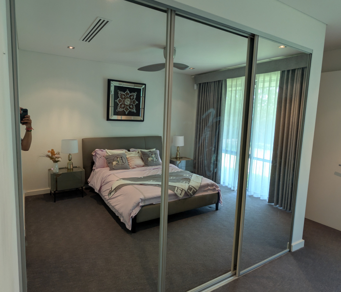Mirrored Glass Sliding Robes reflecting bedroom interior design